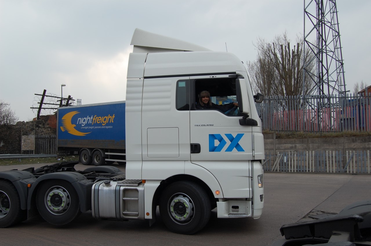 a_white_DX_hgv_tractor_unit_with_a_drver_in_cab