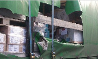 damage_to_a_green_curtain_sided_HGV_trailer_where_thieves_have_entered_to_steal_the_contents