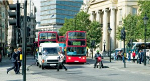 traffic_scene_with_a_red_double_decker_bus_and_white_van_stopped_at_a_pelican_crossing_in_London