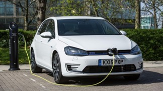 an electric vehicle being charged at motorway service area EV & hybrid driving course car being charged at a motorway service station