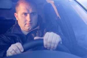 defensive driving refresher course man driving a vehicle with two hands on the steering wheel