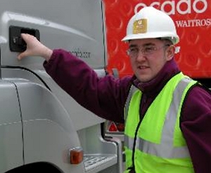 a driver on a cpc course wearing a hi-viz jacket about to climb into the cab of a hgv Ocado-picture